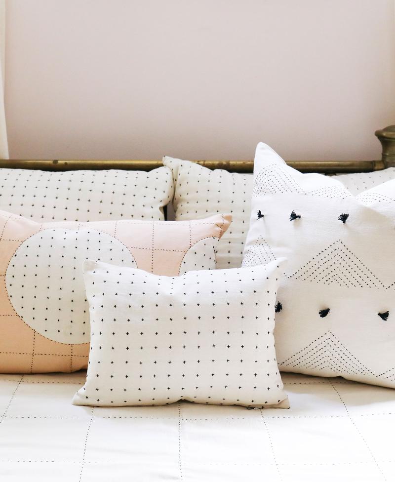 https://www.madetrade.com/cdn/shop/products/cross-stitch-small-throw-pillow-bone-bedding-and-bath-anchal-project-461591_800x.jpg?v=1611943708