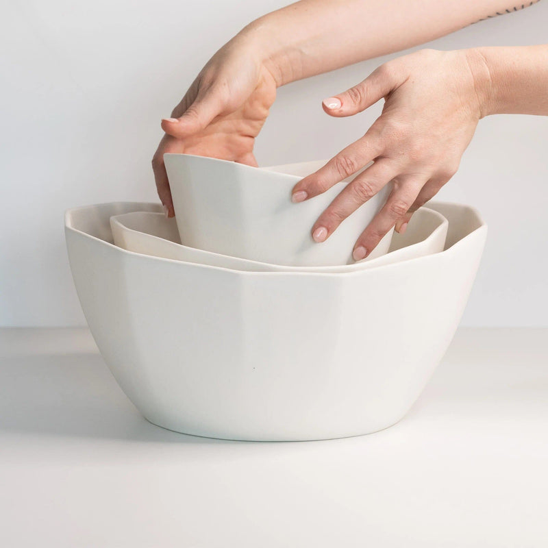https://www.madetrade.com/cdn/shop/products/porcelain-nesting-bowl-set-salad-serving-bowls-the-bright-angle-998298_800x.jpg?v=1674147635